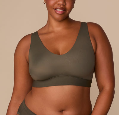 Zarria wearing the Bliss Bralette in Olive. The front view highlights the scoop neckline and buttery-soft Bliss fabric with wide straps for support. sizing: Zarria wears size XL