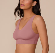 Three-quarter side view of Marcela in the Bliss Bralette in Plum, capturing the bralette’s sleek silhouette and wireless lift from the side.