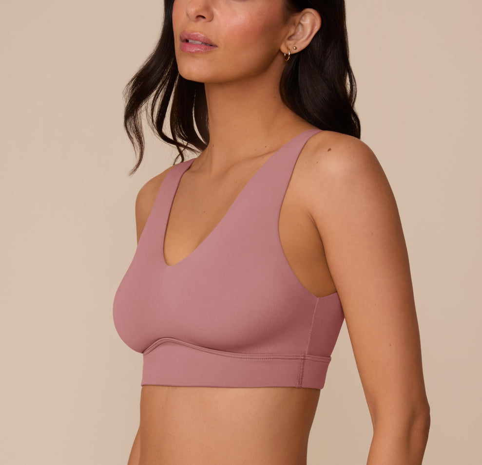 Three-quarter side view of Marcela in the Bliss Bralette in Plum, capturing the bralette’s sleek silhouette and wireless lift from the side.