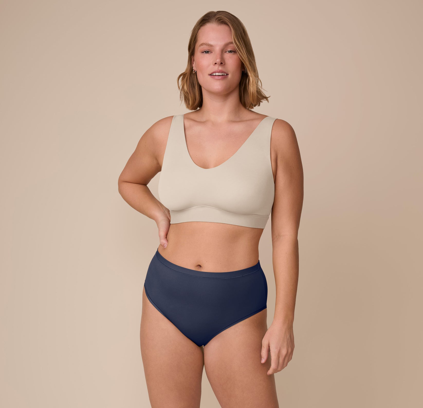Full front view of Sonnie wearing the Bliss Bralette in Sand with the Bliss Highwaist  Brief in True Blue, emphasizing all-day comfort and gentle support.
