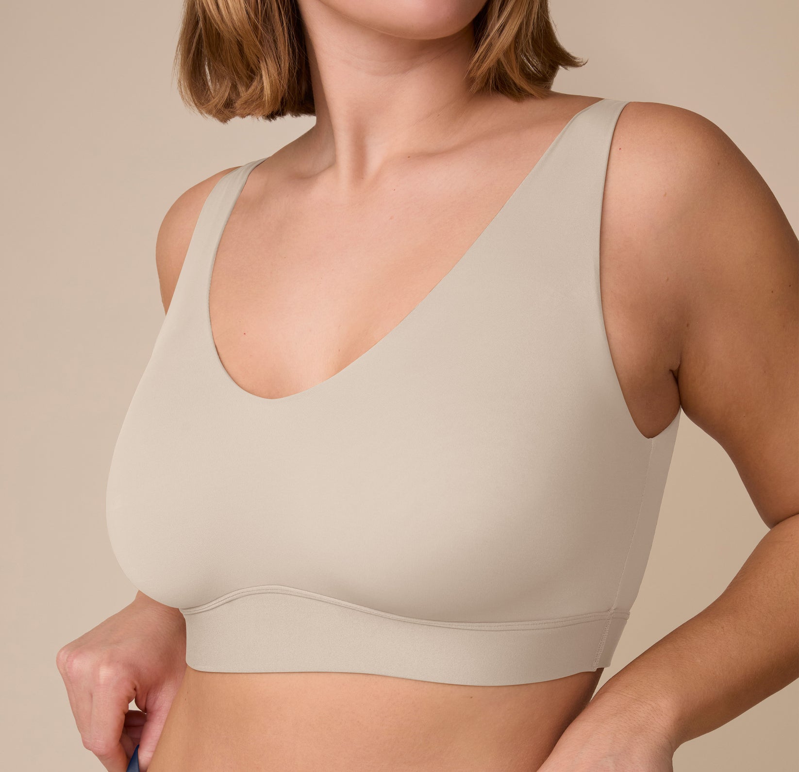 Close-up side angle of the Bliss Bralette in Sand on Sonnie, capturing the ultra-smooth finish and no-dig underband.