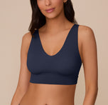 Model Marcela wears the Bliss Bralette in True Blue, shown from the front. The image highlights the plunging V-neckline, wide straps, and smooth underband for wireless support. sizing: Marcela wears size Small