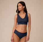 Marcela wearing the Bliss Bralette and matching Bliss Highwaist Brief in True Blue. The image shows the bralette’s clean lines and comfortable coverage in a coordinated set.