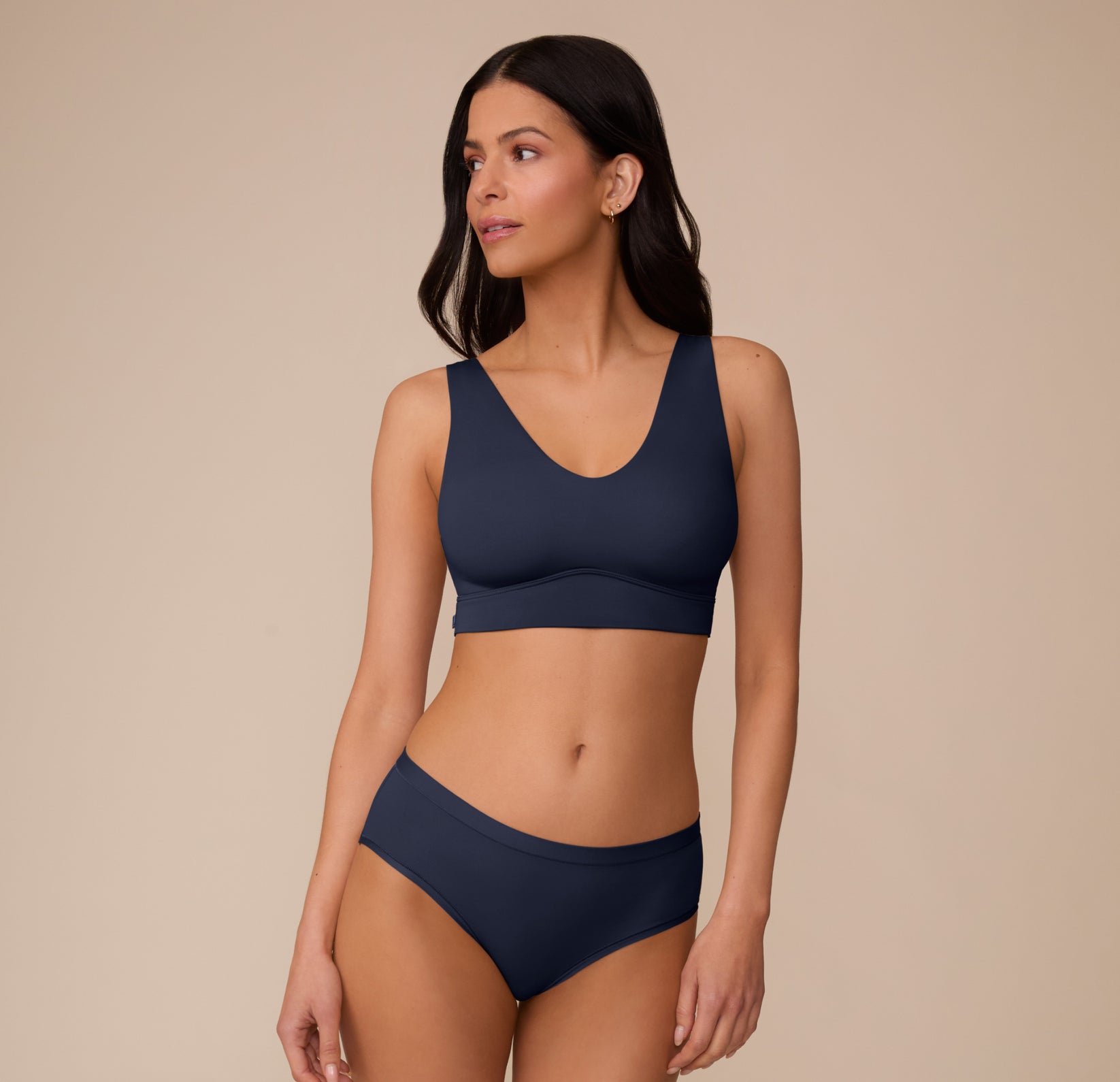 Marcela wearing the Bliss Bralette and matching Bliss Highwaist Brief in True Blue. The image shows the bralette’s clean lines and comfortable coverage in a coordinated set.