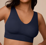Close-up of Marcela wearing the Bliss Bralette in True Blue. The image focuses on the V-neckline, curved underbust seam, and ultra-soft fabric designed for all-day comfort.