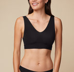 Front view of Anna wearing the Bliss Bralette in Black. The stretchy microfiber fabric and deep V neckline are emphasized. sizing: Anna wears size Small