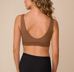 Back view of Freya wearing the Bliss Bralette in Brown. The scoop back offers flexible support and a barely-there feel against the skin.