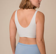 Back view of Sonnie in the Bliss Bralette in Frost. The wide, comfortable straps and scoop back are shown clearly, highlighting the bralette’s minimal seams and ultra-soft finish.