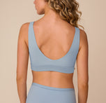 Back view of Freya in the Bliss Bralette in Glacier. The image highlights the deep scoop back, smooth finish, and supportive wide band for a comfortable, barely-there feel.