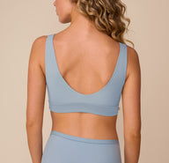 Back view of Freya in the Bliss Bralette in Glacier. The image highlights the deep scoop back, smooth finish, and supportive wide band for a comfortable, barely-there feel.