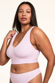 On a light studio backdrop, Alana wears the Bliss Bralette in Retro Lilac with matching underwear, showing the soft microfiber fabric and wireless band designed for everyday comfort.