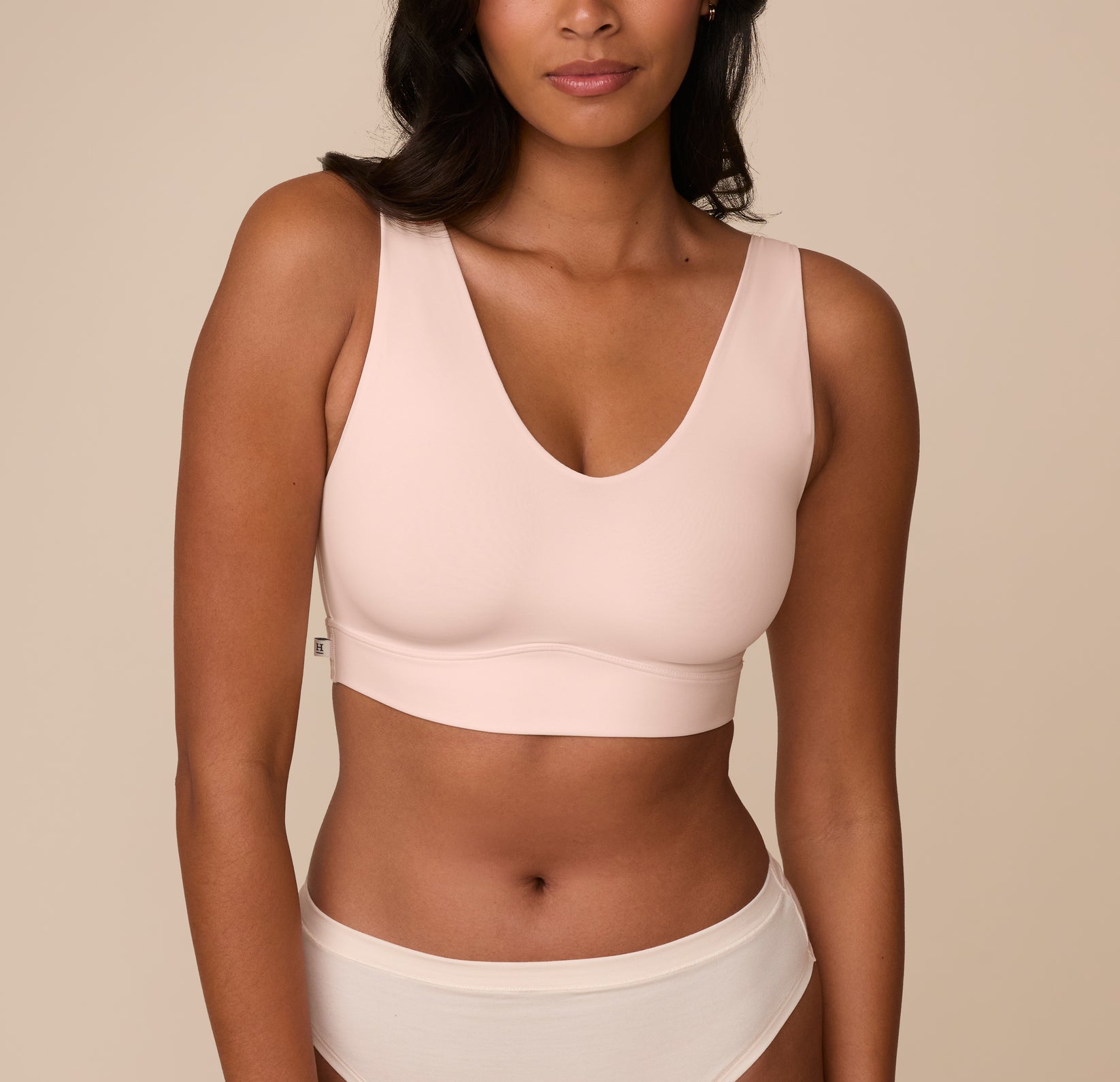 Front view of Victoria wearing the Bliss Bralette in Rose. The soft V neckline and wide straps offer a smooth fit with minimal seams and a supportive underband. sizing: Victoria wears size Medium