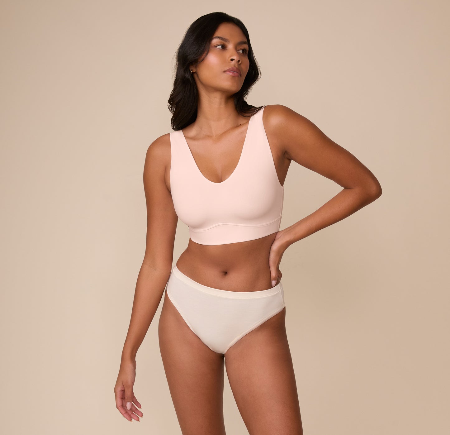 Full body view of Victoria wearing the Bliss Bralette in Rose. The clean lines and soft blush tone create an effortless everyday look.