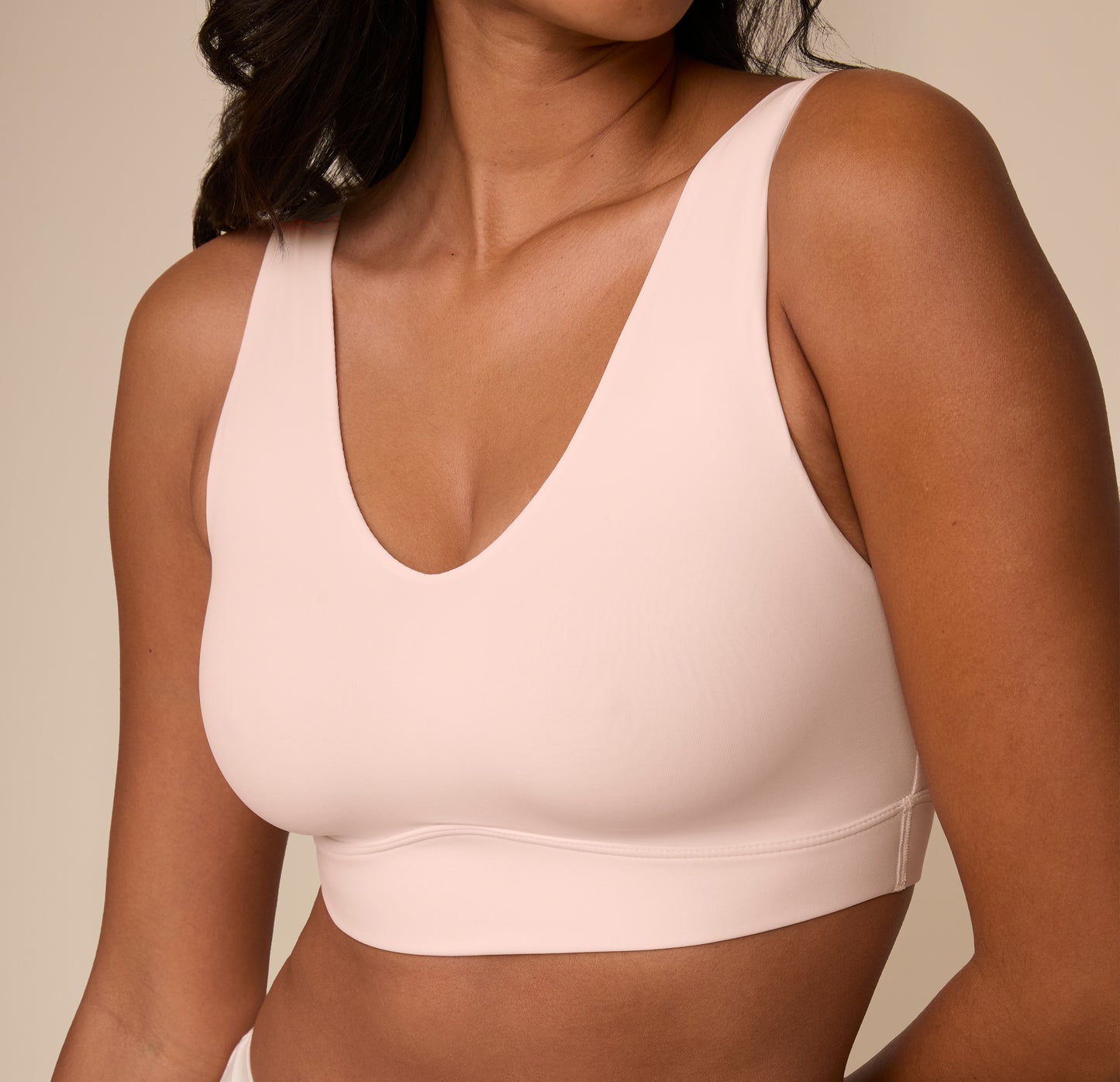 Close-up of Victoria wearing the Bliss Bralette in Rose. The image zooms in on the neckline and subtle shaping of the cups, showcasing the comfort-first design.