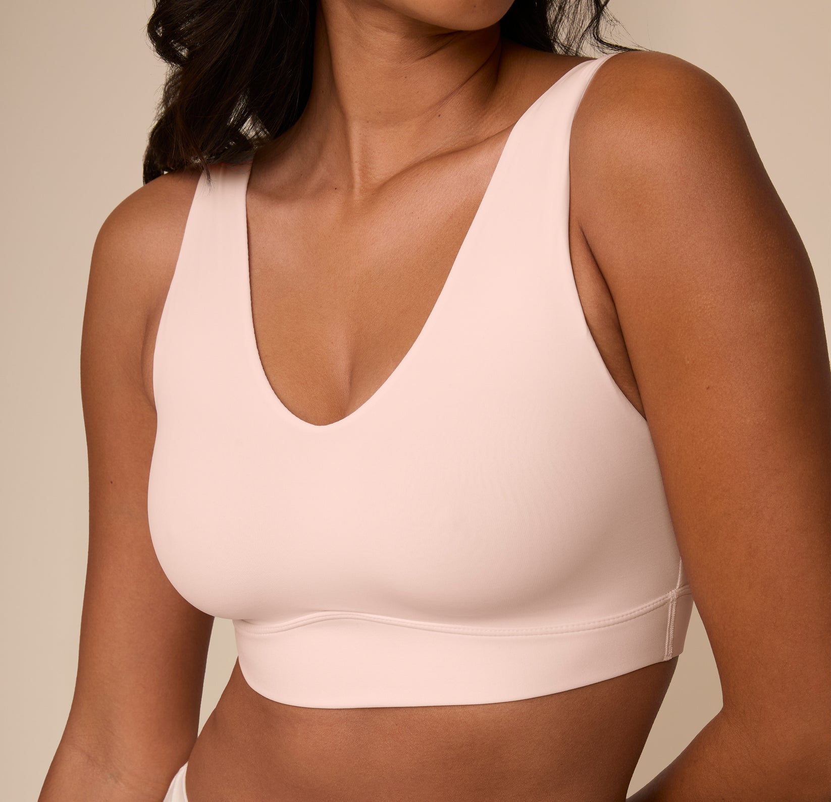Close-up of Victoria wearing the Bliss Bralette in Rose. The image zooms in on the neckline and subtle shaping of the cups, showcasing the comfort-first design.