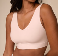 Close-up of Victoria wearing the Bliss Bralette in Rose. The image zooms in on the neckline and subtle shaping of the cups, showcasing the comfort-first design.