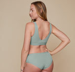 Back view of Erin in the Bliss Bralette and Bliss Hiphugger in Seaglass, highlighting the low-back design and wide, supportive straps of the bralette. 