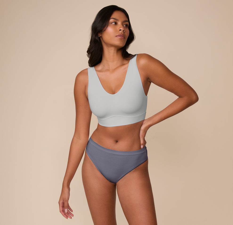 Full-body shot of Victoria wearing the Bliss Bralette in Stormy. The image emphasizes comfort and minimal seams in an everyday set.