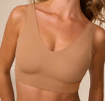 Close-up of Freya wearing the Bliss Bralette in Tan. The image focuses on the soft V neckline and lightly lined cups designed for comfort and subtle lift.