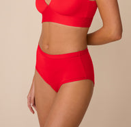 Side view of Freya in the Bliss Highwaist Brief in Cherry. The image emphasizes the soft stretch waistband and light compression fit for everyday comfort.
