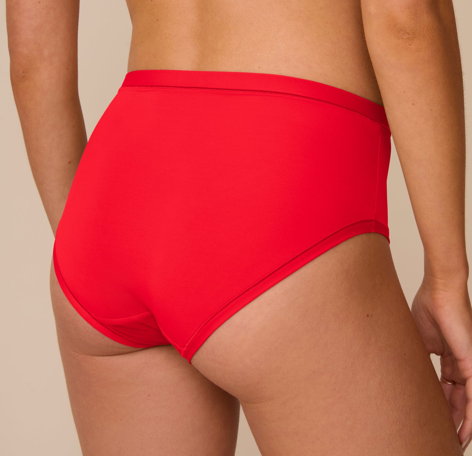 Close-up back view of Freya wearing the Bliss Highwaist Brief in Cherry. The image highlights the smooth microfiber fabric and seamless back coverage.