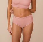sizClose-up of Freya wearing the Bliss Highwaist Brief in Dusty Rose. The brief sits at the natural waist and features Harper Wilde’s soft microfiber fabric with elastic-free edges for all-day comfort. sizing: Freya wears size Small