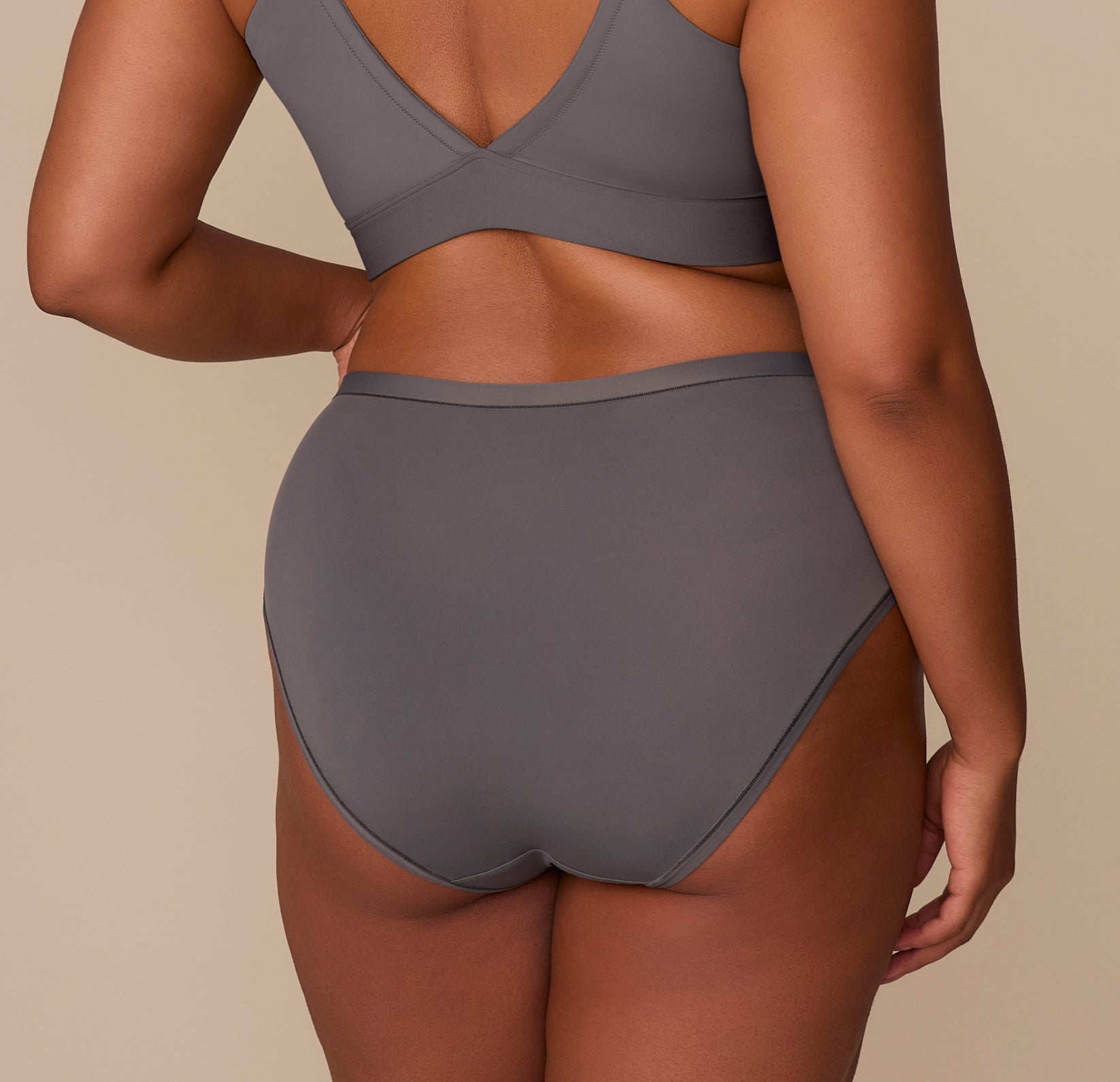 Back view of Zarria in the Bliss Highwaist Brief in Smoke, highlighting the minimal seam look and ultra-soft microfiber fabric with a tagless waistband.