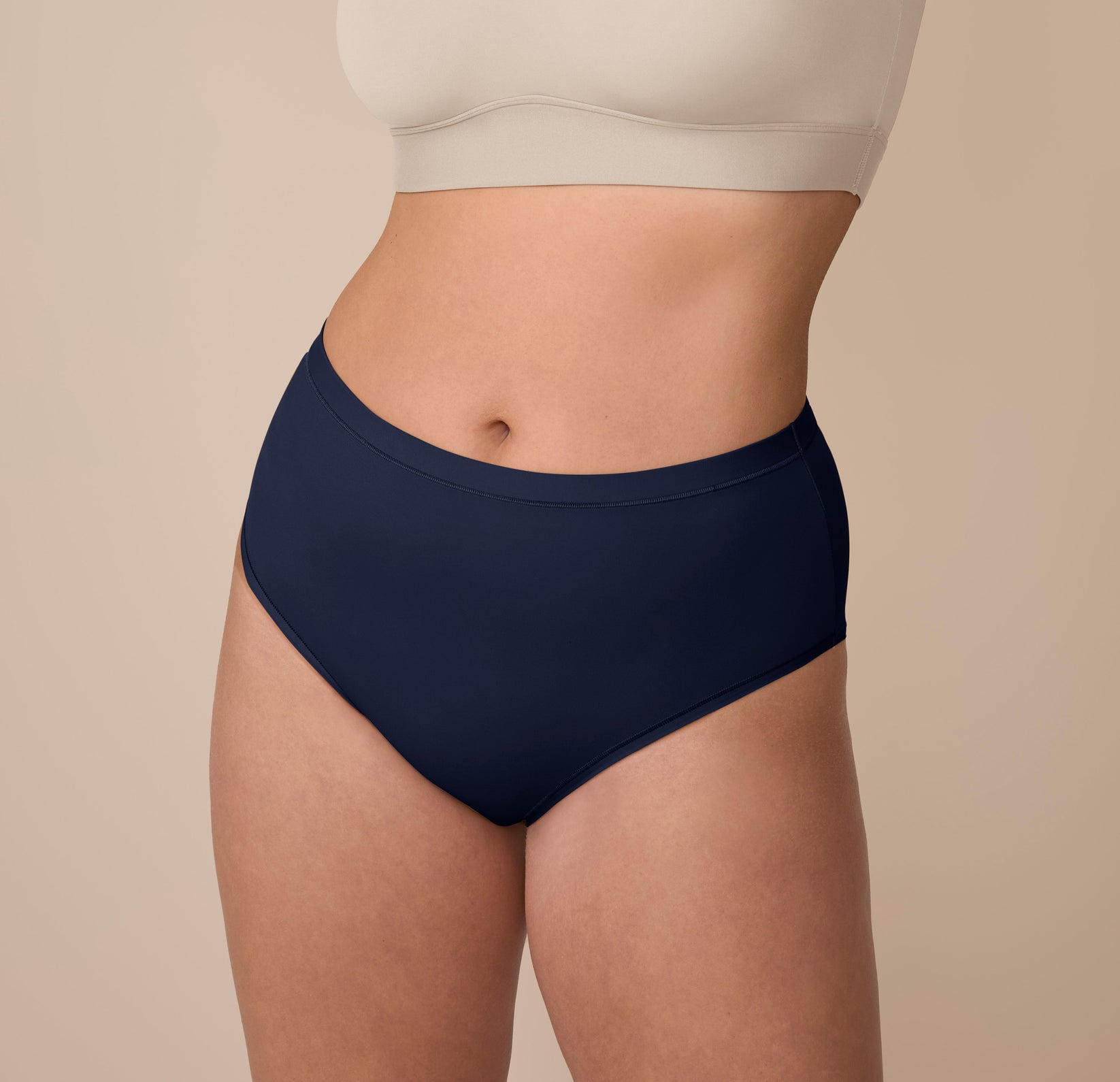 Front view of Sonnie wearing the Bliss Highwaist Brief in True Blue. The image shows the mid-to-high rise fit and smooth, full-coverage front panel. sizing: Sonnie wears size Large