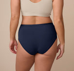 Back view of Sonnie in the Bliss Highwaist Brief in True Blue, highlighting the seamless back design and high-cut leg opening for comfort and mobility.