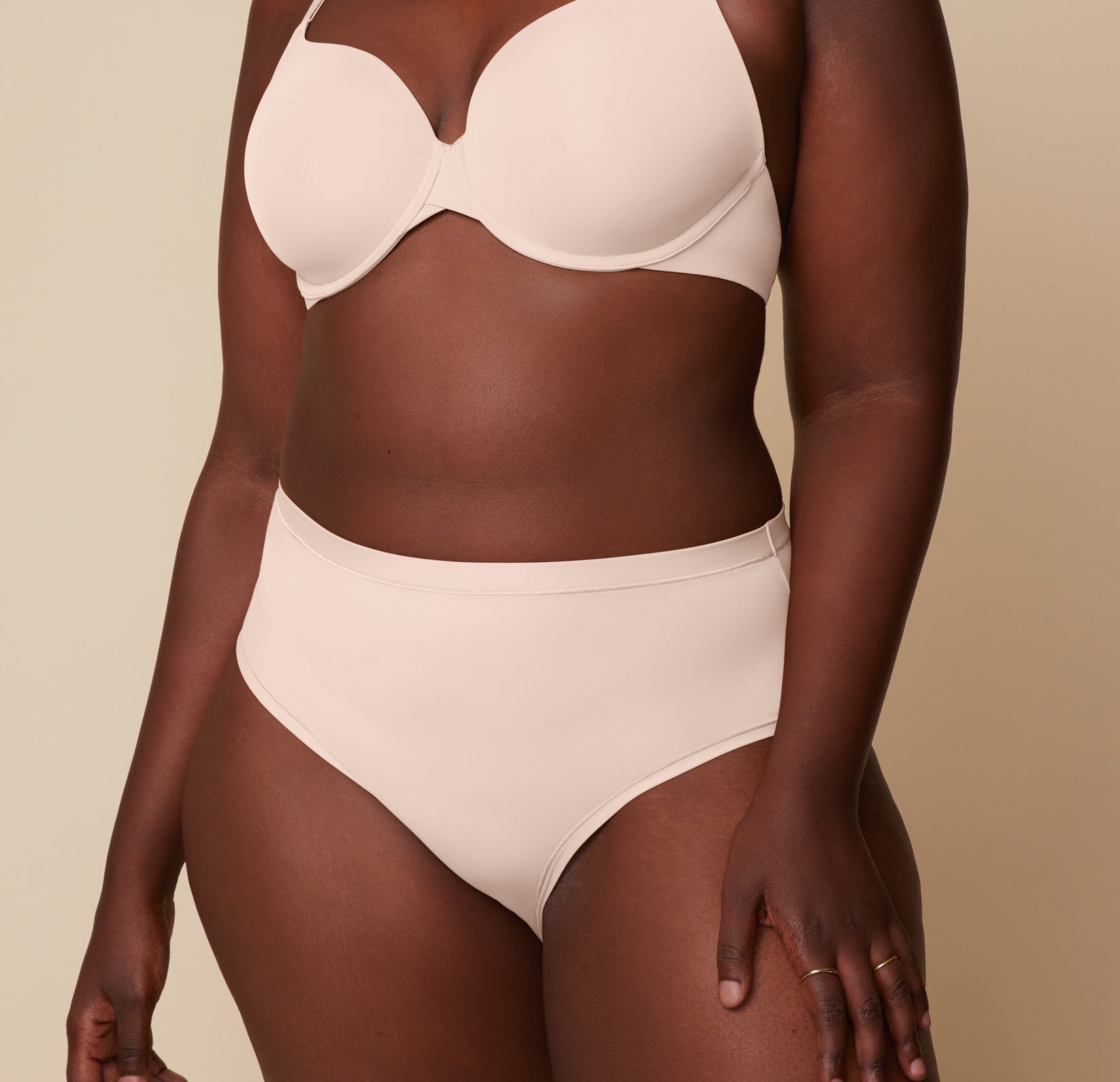 Model Akesha stands in the Base T-Shirt Bra and Bliss Highwaist Brief in Rose, highlighting the comfortable fit and high-rise cut of the brief. sizing: Akesha wears size XL
