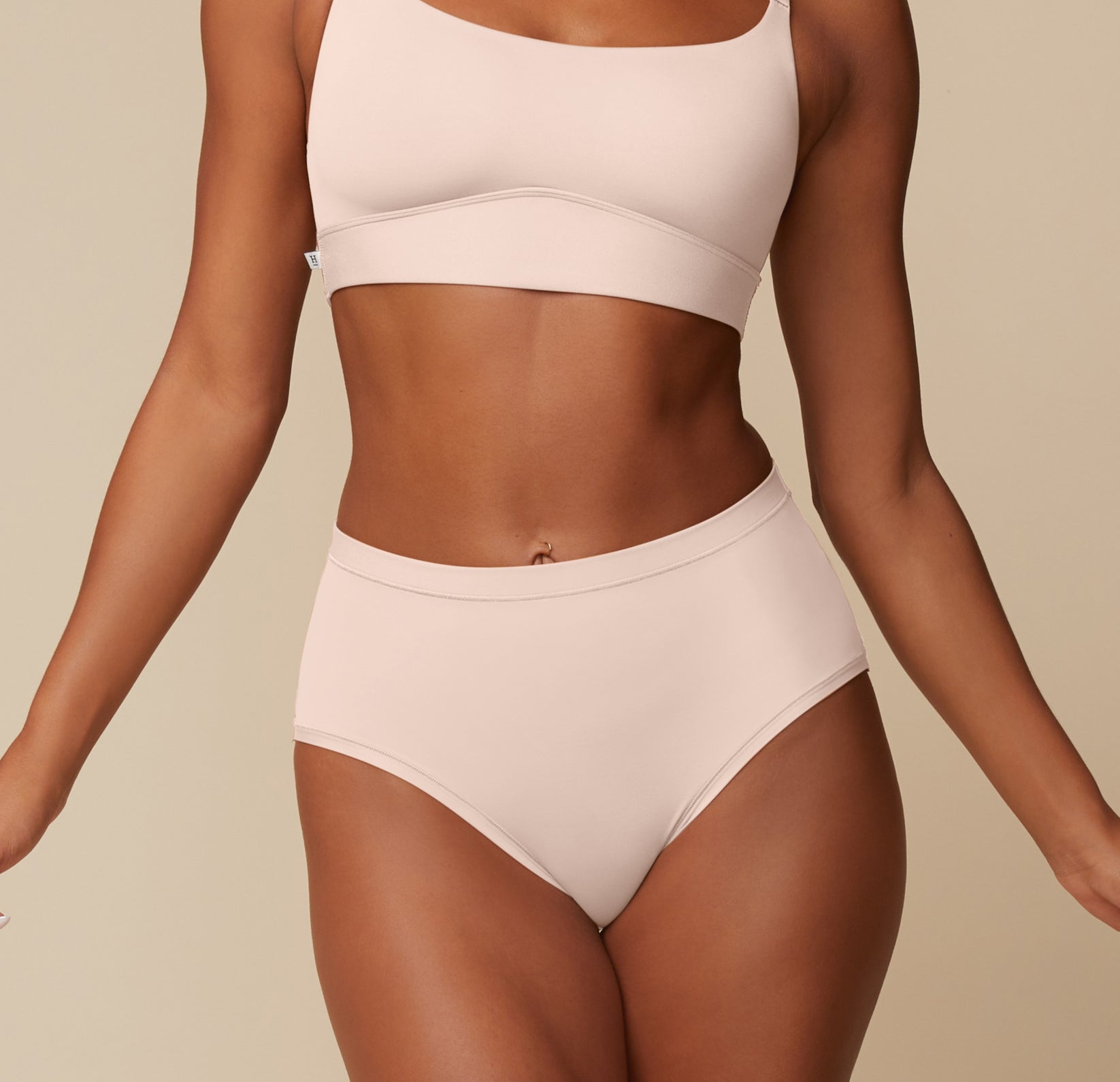 Model Ally stands confidently in the Bliss Scoop and Bliss Highwaist Brief in Rose, showing the soft scoop neckline and full coverage of the high-waisted brief. sizing: Ally wears size Small