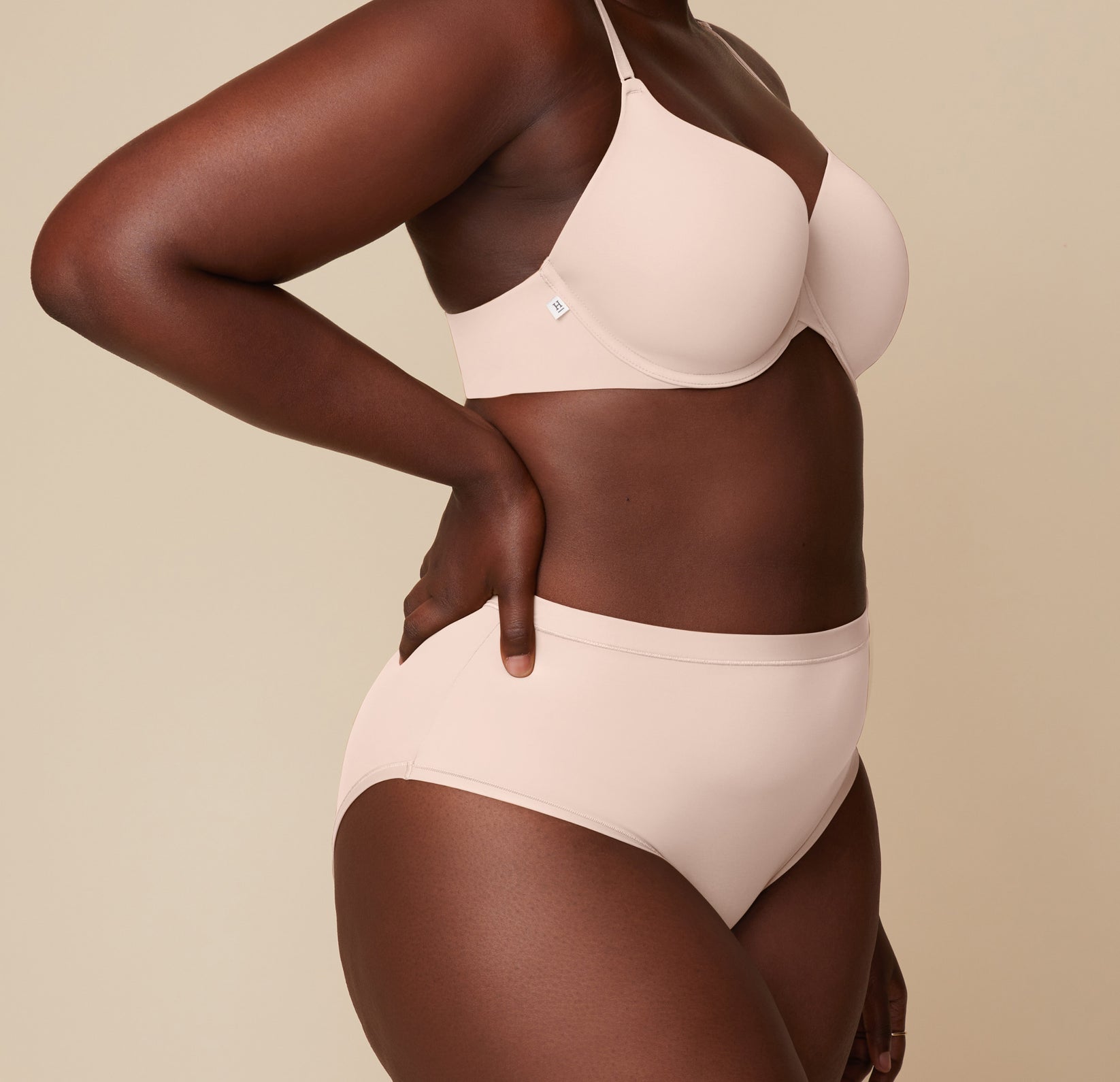 Side view of model Akesha wearing the Base T-Shirt Bra and Bliss Highwaist Brief in Rose, emphasizing the smooth finish and supportive fit of both pieces.