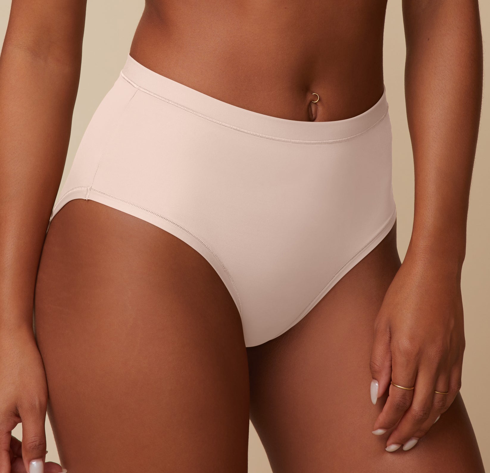 Close-up of Ally wearing the Bliss Highwaist Brief in Rose, focusing on the soft fabric and comfortable, high-rise fit of the brief. 