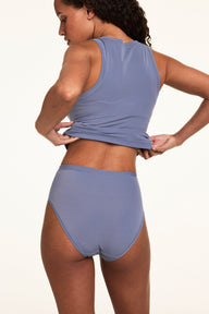 Back view of Courtney wearing the Bliss Highwaist Brief in Steel with a matching Steel tank, highlighting the smooth fabric and full back coverage.