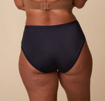A rear view of India showcasing the full-coverage back of the Bliss Highwaist Brief in Black. The fabric lays flat, ensuring a smooth, no-show fit.