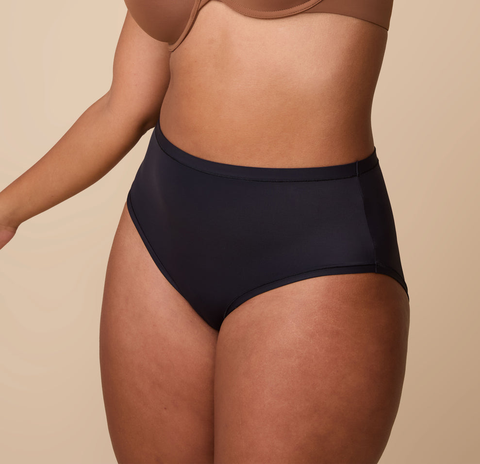 India modeling the Bliss Highwaist Brief from a three-quarter angle, highlighting the flattering high-rise silhouette and soft, smoothing fabric.