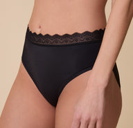 Close-up of the Bliss Lace Highwaist Brief in Black on Gracie, showcasing the intricate lace waistband and smooth, stretchy fabric for a barely-there feel.