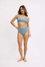 Full-body front view on a white studio backdrop of Darion in the Bliss Highwaist brief in Poolside paired with the Bliss Triangle Bralette, highlighting the high-rise cut and soft microfiber finish.