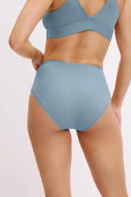 Close-up back view on a white studio backdrop of Darion in the Bliss Highwaist brief in Poolside, focusing on the high waist, full back coverage, and smooth microfiber fabric.