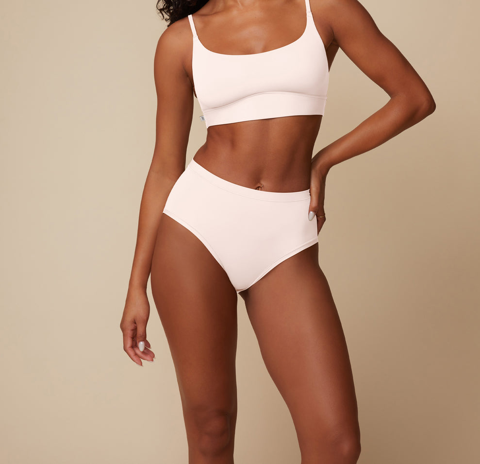 Detailed shot of the Bliss Highwaist Brief in Quartz on Ally, emphasizing the soft stretch and second-skin feel. sizing: Ally wears size Small