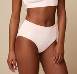 Up close shot of Ally wearing the Bliss Highwaist Brief in Quartz. The high waistband and full coverage front are emphasized. 