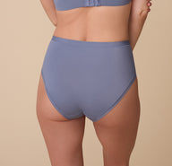 A rear view of Gracie showcasing the full-coverage back of the Bliss Highwaist Brief in Steel. The fabric lays flat against the skin for a sleek fit.