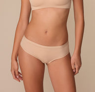Front view of Alexis wearing the Bliss Hiphugger in Beige, showcasing the smooth, mid-rise fit. sizing: Alexis wears size Small