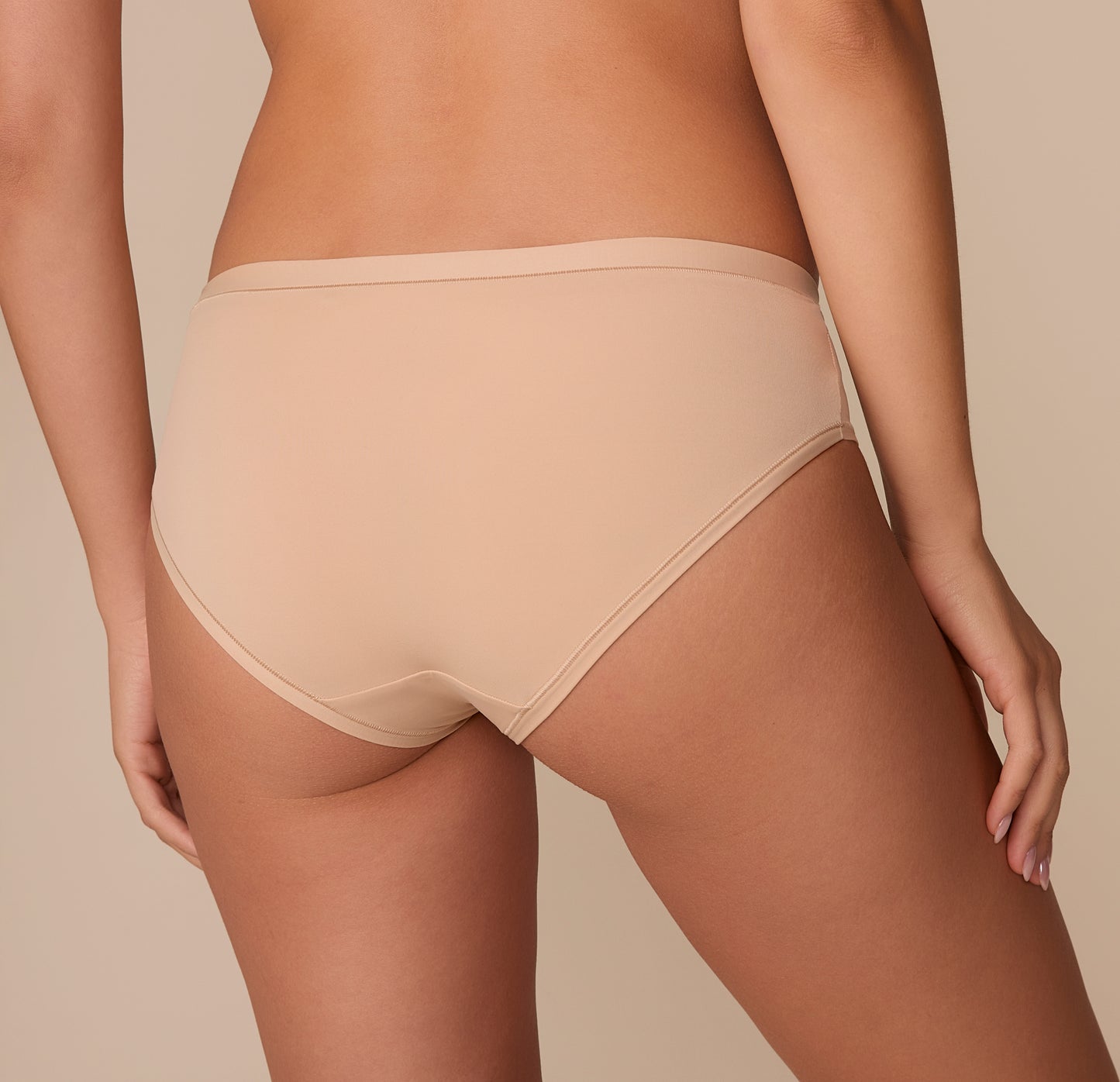 Back-rear view of Alexis in the Bliss Hiphugger, showcasing the smooth edge and soft finish.