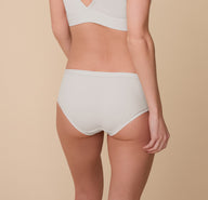 Back view of Gracie wearing the Bliss Hiphugger in Frost, highlighting the full coverage and smoothing microfiber fabric with a cotton gusset for breathable comfort.