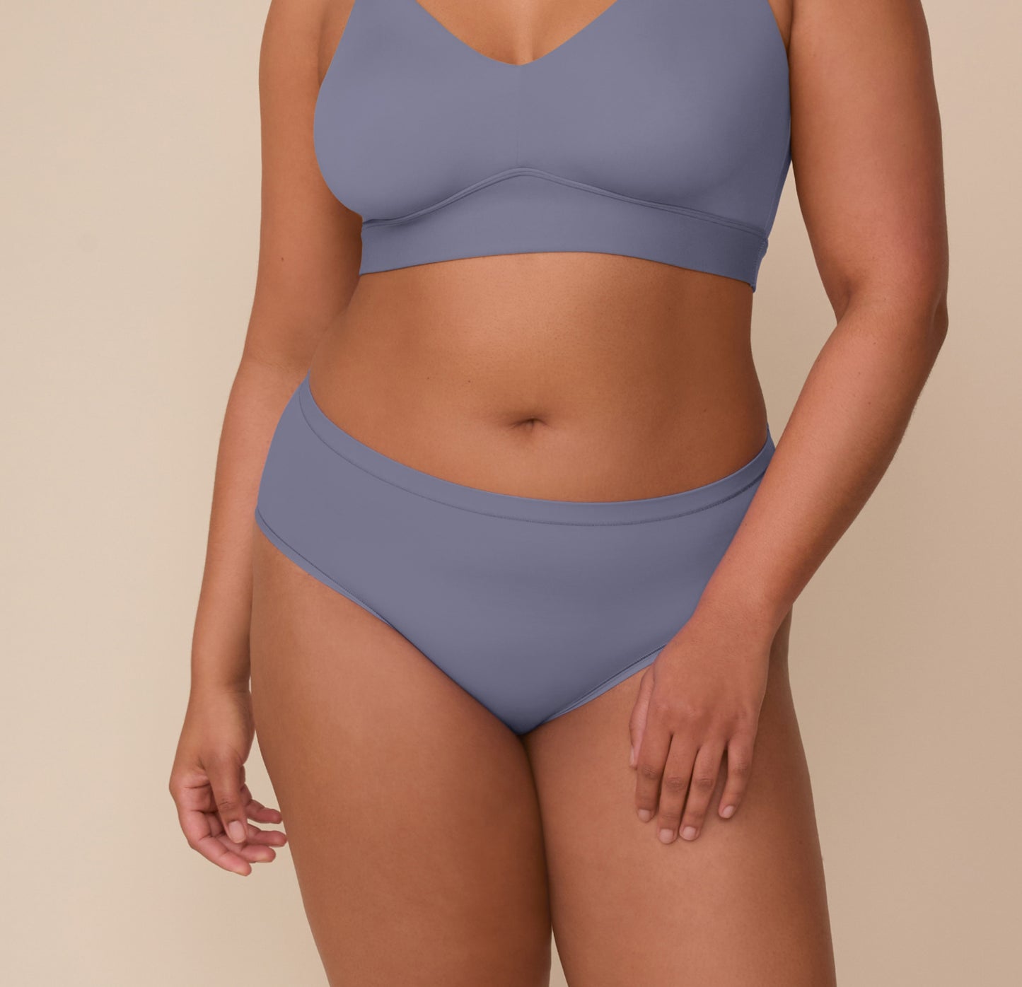 Close-up of Zarria wearing the Bliss Hiphugger in Steel. The image highlights the hip-level rise and smooth waistband of the underwear, paired with the matching Bliss Bralette. sizing: Zarria wears size XL