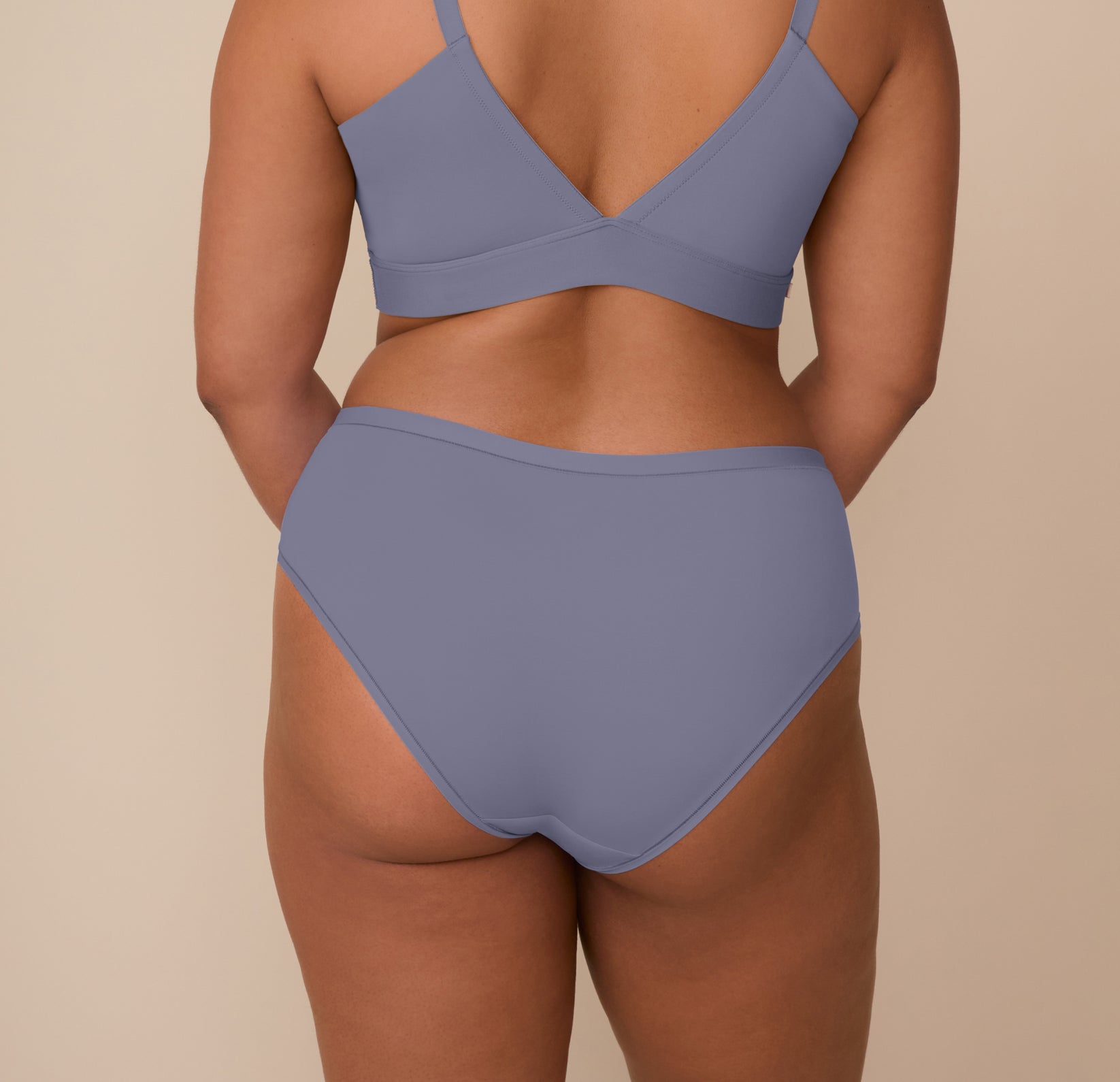 Back view of Zarria wearing the Bliss Hiphugger in Steel. The image emphasizes the full back coverage and the smooth, no-dig edges of the underwear.
