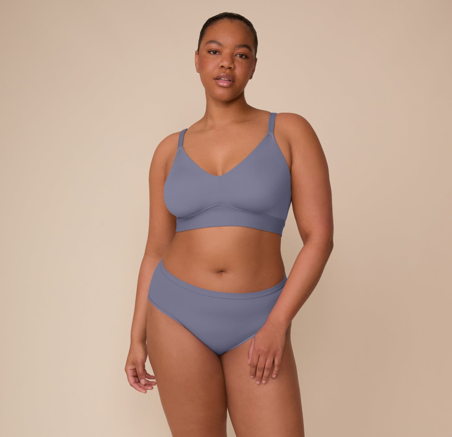 Full-body image of Zarria wearing the Bliss Hiphugger and matching Bliss Triangle Bralette in Steel. The image shows the overall fit, stretch, and softness of the underwear.