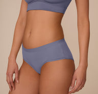 Side view of Marcela wearing the Bliss Hiphugger in Steel. The image showcases the smooth construction and mid-rise cut designed for everyday comfort.