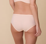 Back view of Gracie wearing the Bliss Hiphugger in Rose. The comfort seams and medium coverage is emphasized.